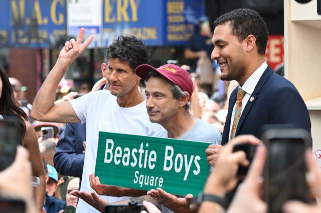 <p>Adam GRAY / AFP) (Photo by ADAM GRAY/AFP via Getty</p> Adam Horovitz, Michael Diamond, and Chris Marte celebrate Beastie Boys Square in New York City