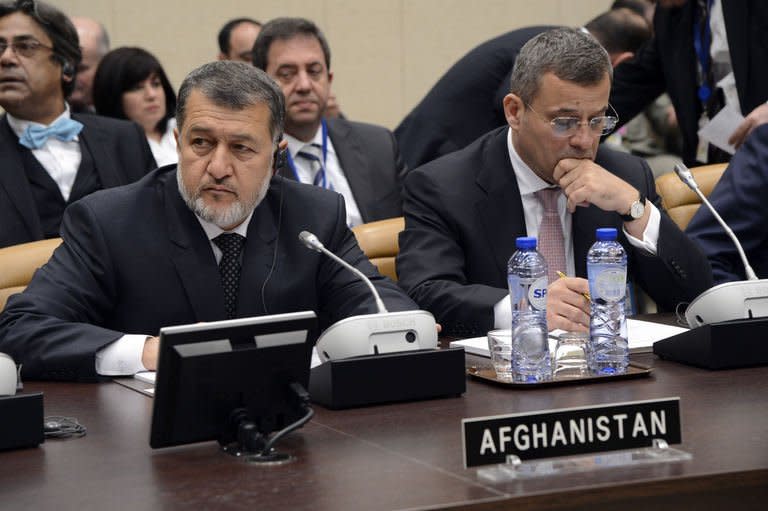 Afghanistan's Defence Minister Bismellah Mohammadi (L) waits prior to the start of the North Atlantic Council meeting of Ministers of Defense and ISAF partners at NATO headquarters in Brussels on February 22, 2013. NATO may station up to 12,000 troops in Afghanistan to train and assist Kabul's forces after its combat mission against the Taliban ends there in 2014, US officials said Friday