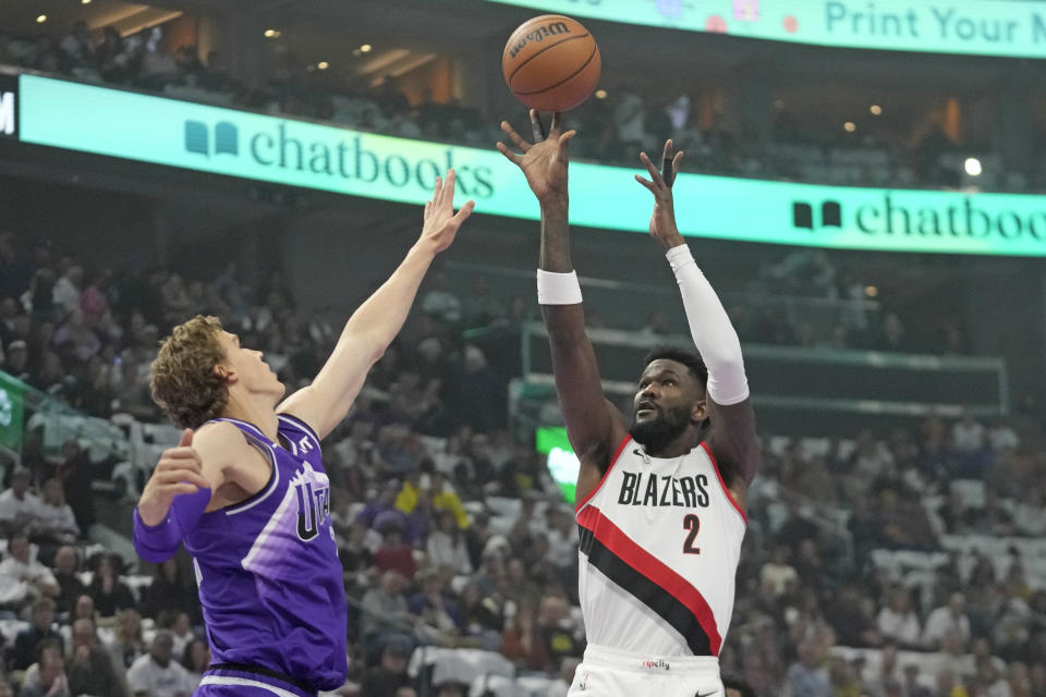 Portland Trail Blazers center Deandre Ayton (2) shoots as Utah Jazz forward Lauri Markkanen, left, defends during the first half of an NBA basketball in-season tournament game, Tuesday, Nov. 14, 2023, in Salt Lake City. (AP Photo/Rick Bowmer)