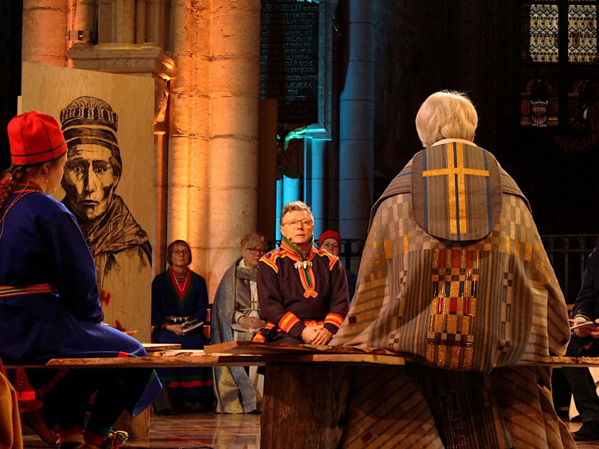 At a special service in Uppsala Cathedral on Nov. 24, Archbishop Antje Jackelén, centre, of the Church of Sweden addresses a circle of Sámi leaders to apologize for her church’s past crimes against the Sámi, Indigenous people who live on parts of Sweden, Norway, Finland and northern Russia. (John Last/CBC - image credit)