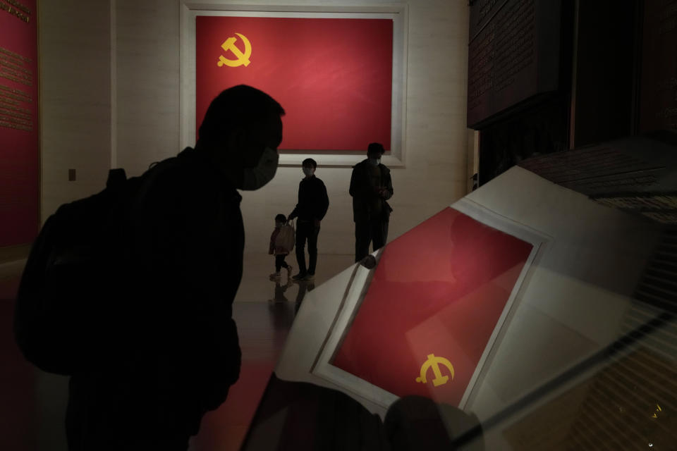 Visitors pass by the Communists party flags at the Museum of the Community Party of China in Beijing, Wednesday, Oct. 12, 2022. A meeting of the ruling Communist Party to install leaders gives President Xi Jinping, China's most influential figure in decades, a chance to stack the ranks with allies who share his vision of intensifying pervasive control over entrepreneurs and technology development. (AP Photo/Ng Han Guan)