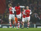 Arsenal's Yaya Sanogo (C) celebrates with his team mates after scoring a goal against Borussia Dortmund during their Champions League group D soccer match in London November 26, 2014. REUTERS/Eddie Keogh