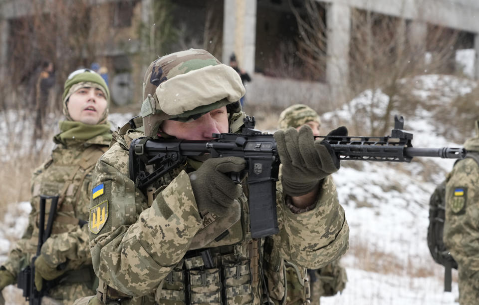 Members of Ukraine's Territorial Defense Forces, volunteer military units of the Armed Forces, train close to Kyiv, Ukraine, Saturday, Jan. 29, 2022. Dozens of civilians have been joining Ukraine's army reserves in recent weeks amid fears about Russian invasion. (AP Photo/Efrem Lukatsky)