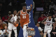 Texas's Ze'Rik Onyema reacts during the first half of an NCAA college basketball game against Louisville, Sunday, Nov. 19, 2023, in New York. (AP Photo/Seth Wenig)