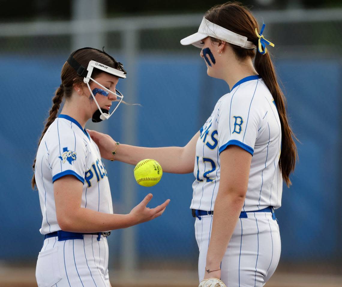 Boswell first baseman Danielle Bohanon (12) attempts to calm pitcher Harley Malone (3) after she hit a batter in the first inning during a high school softball game at Boswell High School in Saginaw, Texas, April 16, 2024. Boswell defeated Trinity 6-0 which left the two teams tied for first place. (Special to the Star-Telegram/Bob Booth)