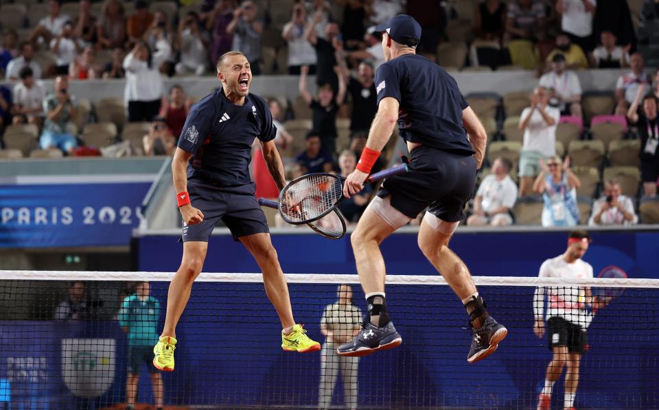 Dan Evans of Team Great Britain celebrates with partner Andy Murray