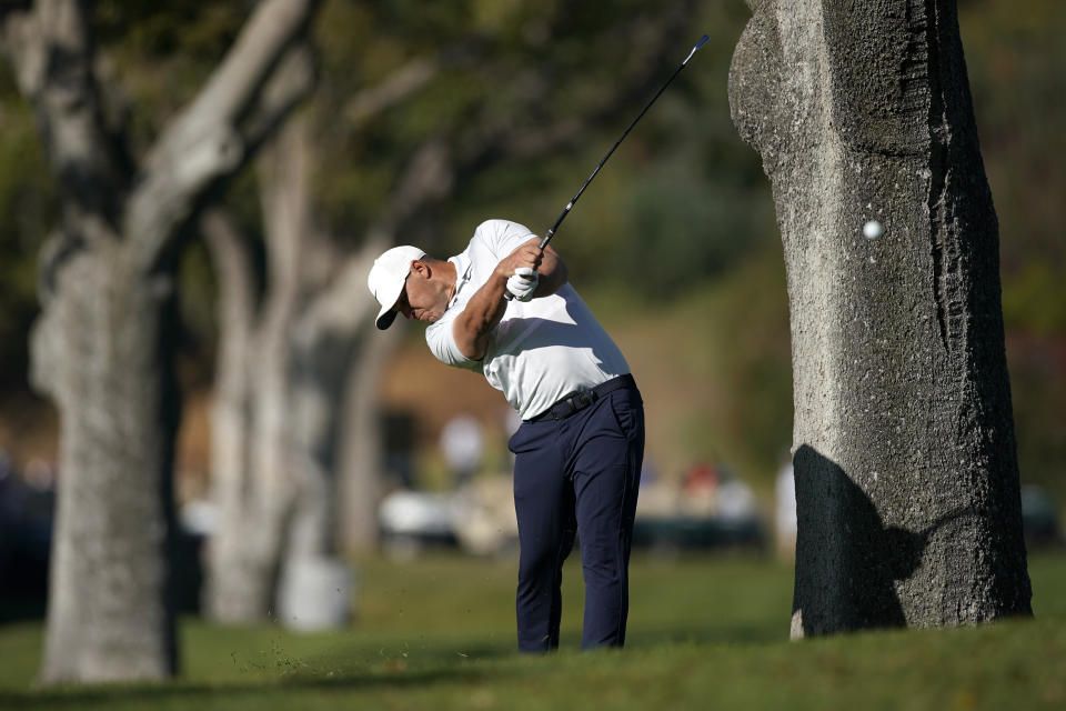 Brooks Koepka hits his second shot from the rough on the first hole during the final round of the Genesis Invitational golf tournament at Riviera Country Club, Sunday, Feb. 16, 2020, in the Pacific Palisades area of Los Angeles. (AP Photo/Ryan Kang)