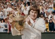 <p>Jimmy Connors holds the trophy after winning the Men's Singles Final match against Ken Rosewall in July 1974.</p>