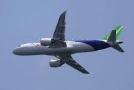 A Comac C919 flies past during an aerial flying display ahead of the Singapore Airshow at Changi Exhibition Centre in Singapore