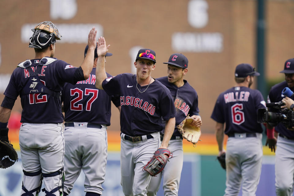 Cleveland Guardians center fielder Myles Straw greets team members after the 10th inning of a baseball game against the Detroit Tigers, Thursday, Aug. 11, 2022, in Detroit. (AP Photo/Carlos Osorio)