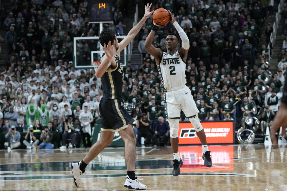 Michigan State guard Tyson Walker (2), defended by Purdue guard Ethan Morton attempts a last second shot during the second half of an NCAA college basketball game, Monday, Jan. 16, 2023, in East Lansing, Mich. (AP Photo/Carlos Osorio)