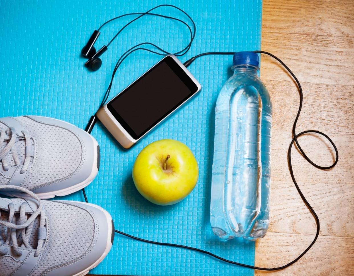 Best Podcasts to Listen to While Going for a Walk: sneakers, phone, headphones