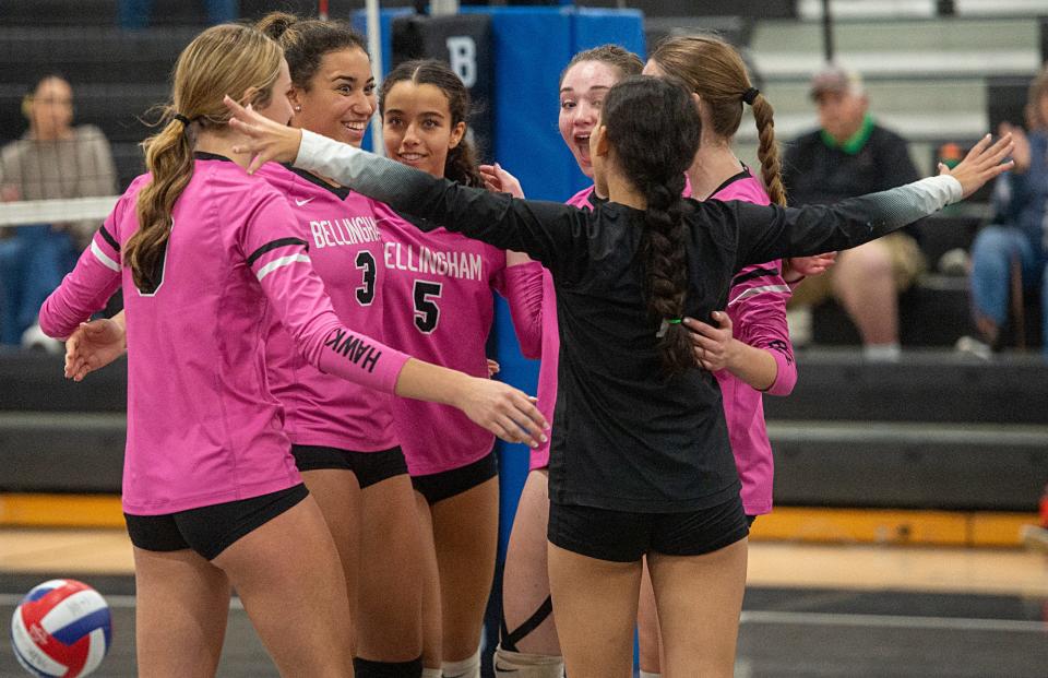 The Bellingham High School volleyball team, including #3, Ciara Crayton, and #5, Mady DeOliveira, celebrate its win, 3-0, against Dedham, Oct. 25, 2023.