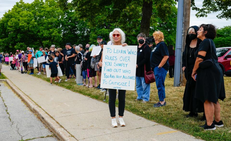 Lisa Bieri of Brookfield attends a silent rally outside the Waukesha School District building at 301 Hyde Park Ave. as seen on Wednesday, July 12, 2023. The rally is a show of support for Heyer Elementary School teacher Melissa Tempel, who was put on administrative leave after criticizing the Waukesha School District for banning the song "Rainbowland" from a spring concert.