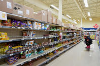 <p>Two individuals look at a popular trend for Atlantic Canada, storm chips, in the Dominion grocery store before the arrival of Hurricane Fiona, in Corner Brook, Nfld. on Sept. 23, 2022. (REUTERS/John Morris)</p> 