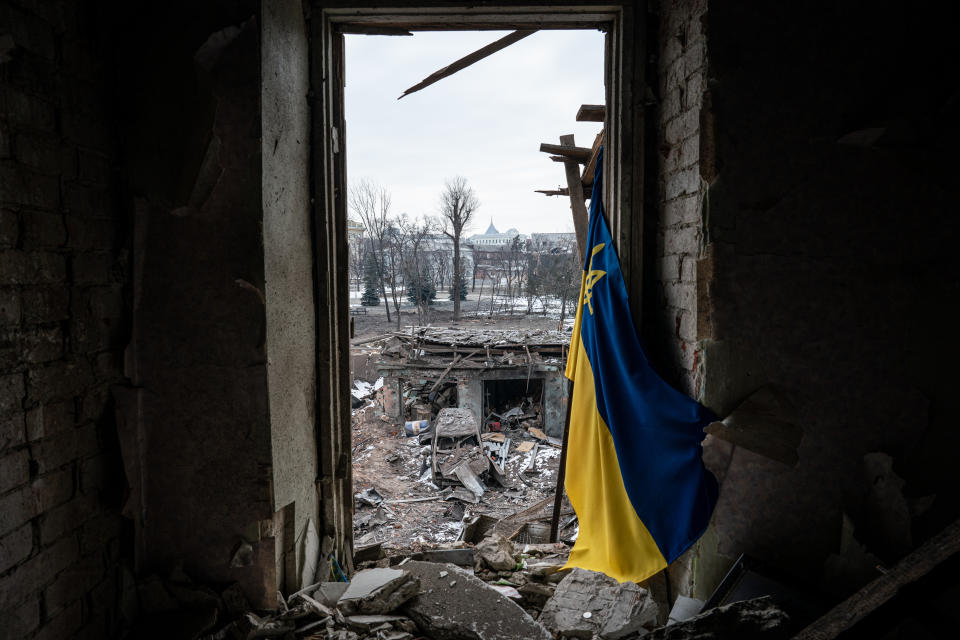 A blue and gold Ukrainian flag stands upright amid rubble left by shelling in Kharkiv, Ukraine, on Monday. (Wolfgang Schwan/Anadolu Agency via Getty Images)