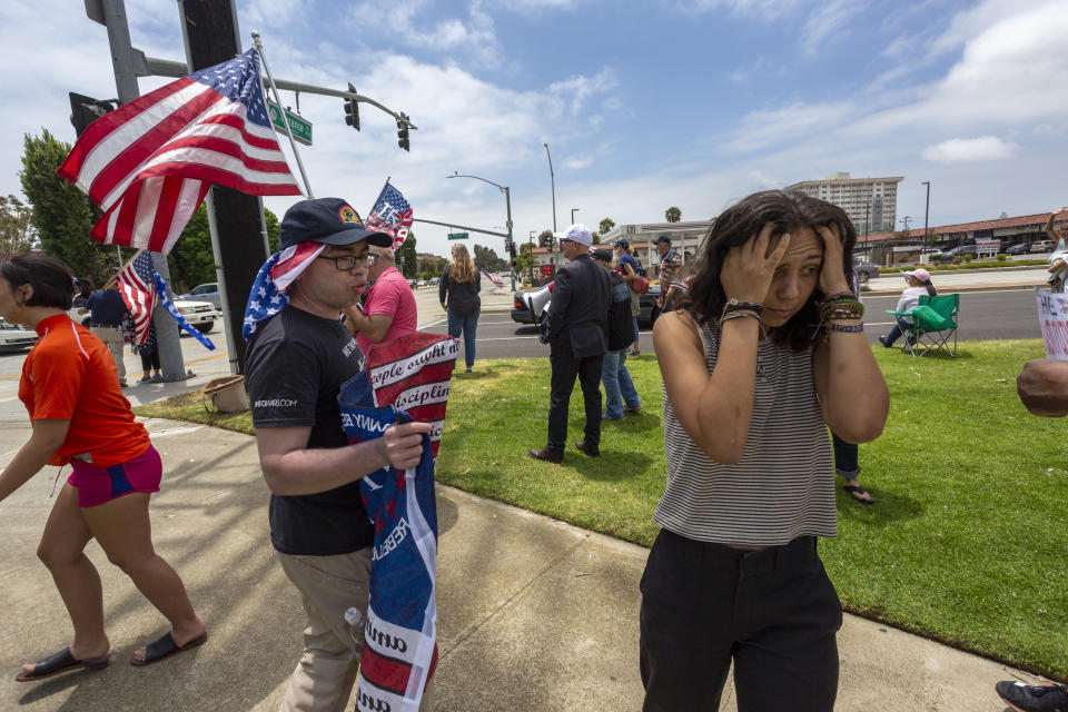 TORRANCE, CA - JUNE 20: A woman turns away in frustration after arguing with a supporter of President Donald Trump at a pro-police rally as demonstrators across the nation protest racism and police brutality on June 20, 2020 in Torrance, California. The president has attracted criticism for threatening to use police tactics against protesters near his campaign rally in Tulsa, Oklahoma today, his first since the start of the coronavirus pandemic, and for shunning coronavirus safety measures called for by healthcare professionals. COVID-19 cases are accelerating in Tulsa and in California, where Gov. Gavin Newsom this week issued a statewide order to wear face coverings. (Photo by David McNew/Getty Images)