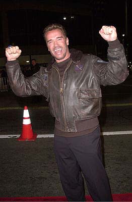 Arnold Schwarzenegger declares himself victorious after pummeling a wiseacre valet into unconsciousness at the Mann's National Theater premiere of Columbia's The 6th Day