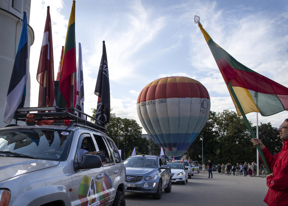 The national attributes decorated cars take part in a traditional race Vilnius-Riga-Tallinn dedicated to the 30th anniversary of the Baltic Way at the Cathedral Square in Vilnius, Lithuania, Friday Aug. 23, 2019. Estonia’s prime minister says one should never forget the 1989 “Baltic Way” in which nearly 2 million people of then-Soviet Lithuania, Latvia and Estonia formed a human chain more than 600 kilometers (370 miles) long to protest Soviet occupation. (AP Photo/Mindaugas Kulbis)