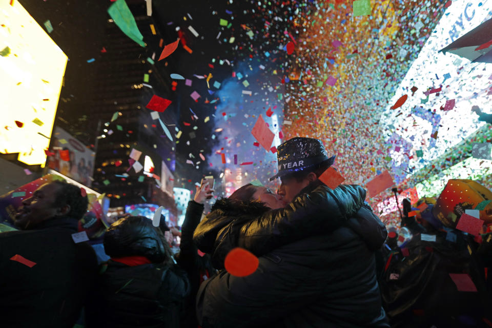 Joey and Claudia Flores, of California, kiss as confetti falls during a New Year's celebration in New York's Times Square, Tuesday, Jan. 1, 2019. (AP Photo/Adam Hunger)