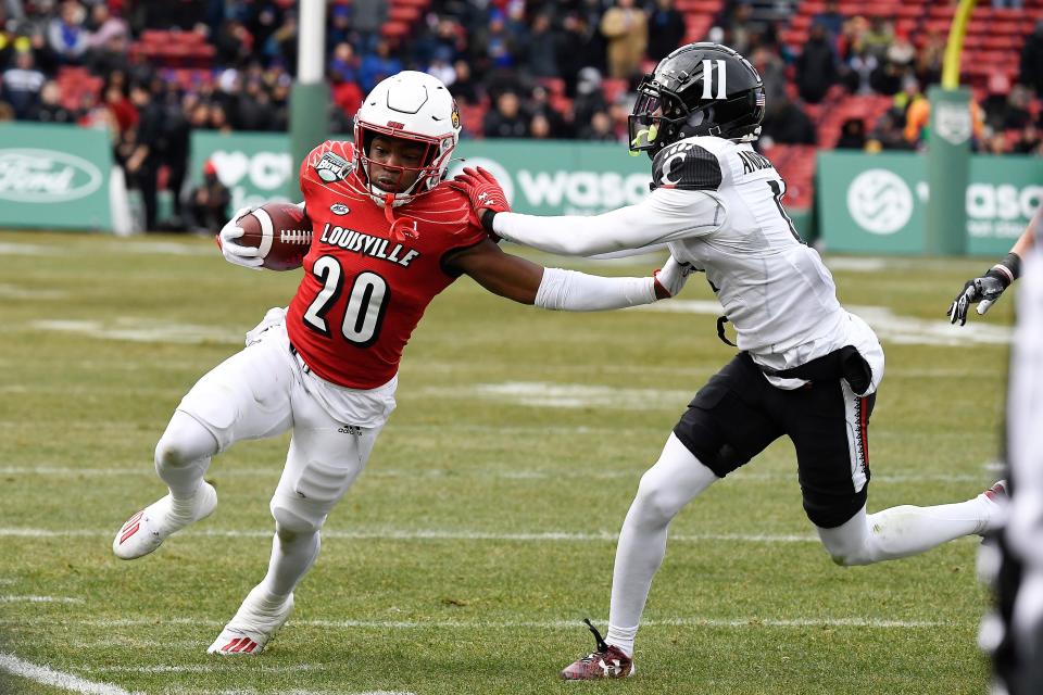 Louisville running back Maurice Turner (20) is forced out of bounds during the first half of the Fenway Bowl vs. Cincinnati.