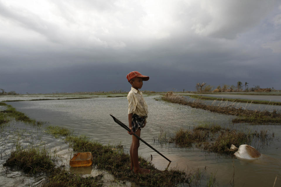 A boy whose house was destroyed by the cyclone watches an approaching storm, some 50 kilometres southwest of the township of Kunyangon. Further storms would complicate relief efforts and leave children increasingly vulnerable to disease. In May 2008 in Myanmar, an estimated 1.5 million people are struggling to survive under increasingly desperate conditions in the wake of Cyclone Nargis, which hit the southwestern coast on 3 May, killed some 100,000 people, and displaced 1 million across five states. Up to 5,000 square kilometres of the densely populated Irrawaddy Delta, which bore the brunt of the storm, remain underwater.&nbsp;