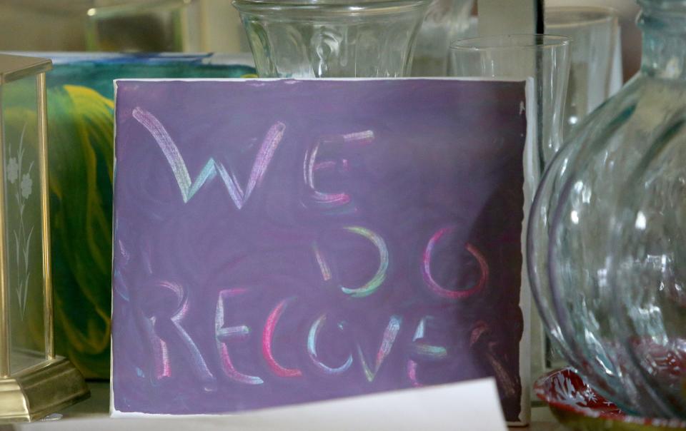 Many signs of encouragement, such as this one in a cabinet in the dining room that says, "We do recover," are on display Wednesday, Dec. 20, 2023, at Dismas House in South Bend.