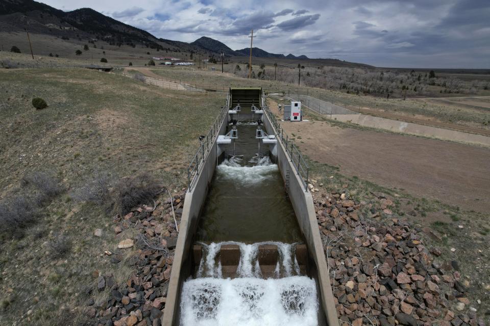 Water flows through an irrigation canal with a turbine at Ralston Reservoir in Arvada Colo. on Thursday, April 13, 2023. Emrgy, a business that places small turbines in irrigation canals to generate electricity, has raised $18.4 million to scale up its technology and generate carbon-free hydropower. (AP Photo/Brittany Peterson)