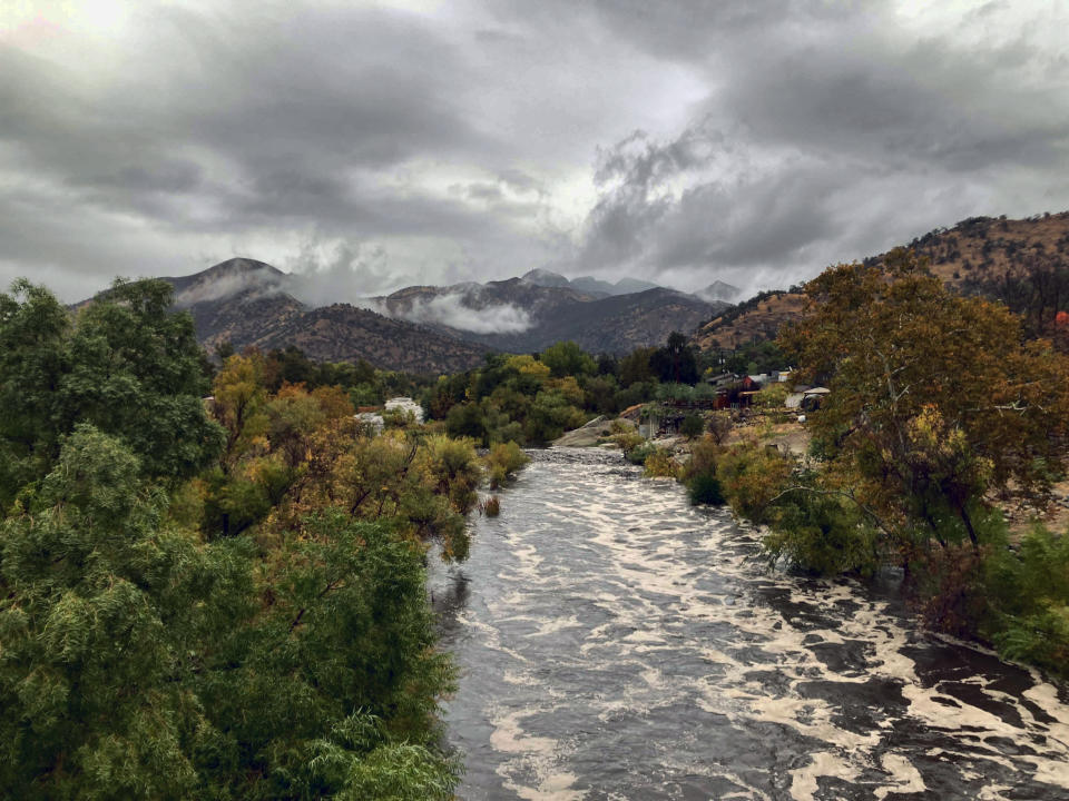 The North Fork of the Kaweah River, which flows from Sequoia National Park, is swollen with frothy, black water, Monday, Oct. 25, 2021, in Three Rivers, Calif. (AP Photo/Brian Melley)