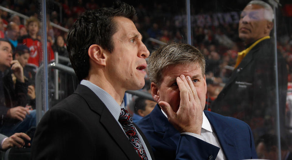 NEWARK, NJ - MARCH 01: Head coach Bill Peters of the Carolina Hurricanes speaks with assistant coach Rob Brind'Amour during the first period against the New Jersey Devils at the Prudential Center on March 1, 2016 in Newark, New Jersey.  (Photo by Bruce Bennett/Getty Images)