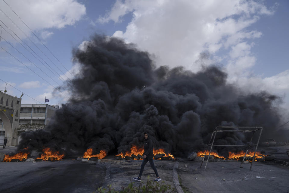 Palestinian protesters block the main road with burning tires in the West Bank city of Jericho, Monday, Feb. 6, 2023. Israeli forces killed five Palestinian gunmen in a raid on refugee camp in the occupied West Bank on Monday, the latest bloodshed in the region that will likely further exacerbate tensions.(AP Photo/Nasser Nasser)