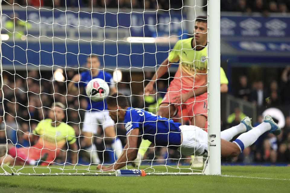 Everton's Dominic Calvert-Lewin dives in to score his side's first goal of the game against Manchester City during their English Premier League soccer match at Goodison Park in Liverpool, England, Saturday Sept. 28, 2019. (Peter Byrne/PA via AP)