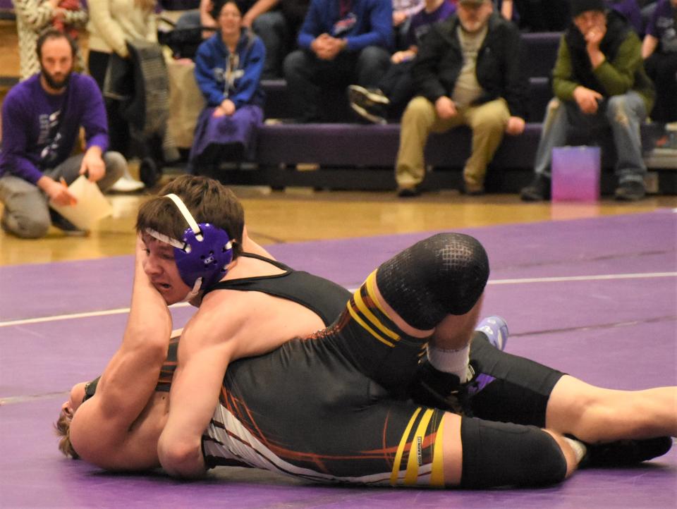 Canajoharie/Fort Plain wrestler Alex Smith pushes Little Falls Mountie Matt Verri (right) away while trying to avoid being pinned at 145 pounds Thursday.