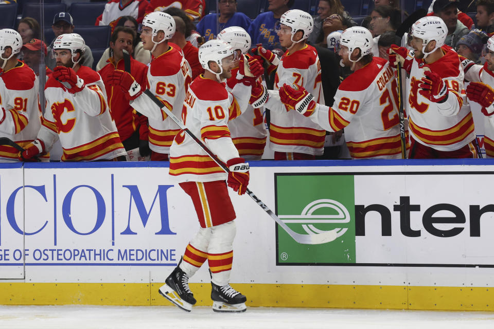 Calgary Flames center Jonathan Huberdeau (10) celebrates after his goal during the first period of an NHL hockey game against the Buffalo Sabres, Thursday, Oct. 19, 2023, in Buffalo, N.Y. (AP Photo/Jeffrey T. Barnes)