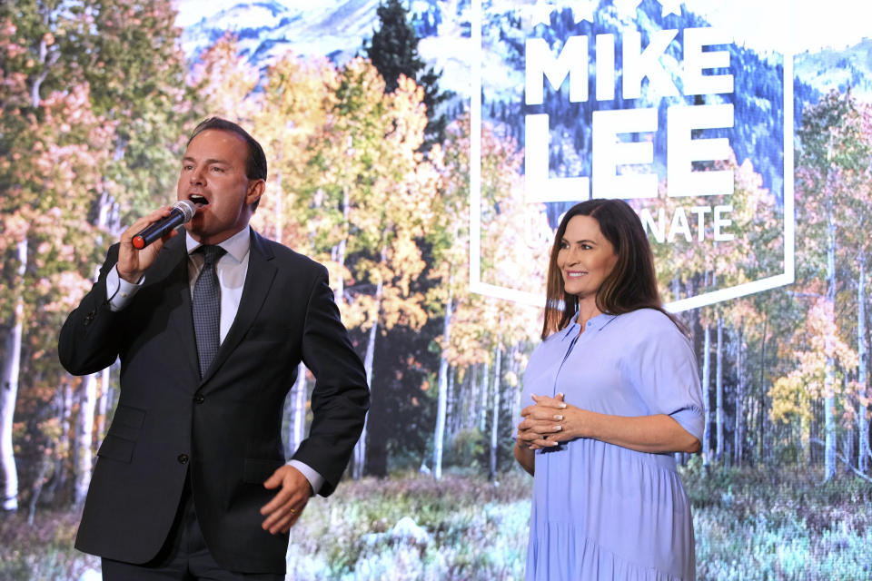 U.S. Sen. Mike Lee, left, of Utah, and his wife, Sharon Lee, talk to supporters during a Utah Republican election night party, Tuesday, June 28, 2022, in South Jordan, Utah. (AP Photo/George Frey)