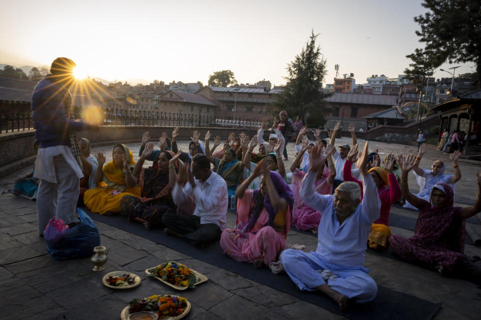 A Nepalese priest performs rituals for Indian pilgrims at Pashupatinath temple premises in Kathmandu, Nepal, Jan. 9, 2024. The centuries-old temple is one of the most important pilgrimage sites in Asia for Hindus. Nepal and India are the world’s two Hindu-majority nations and share a strong religious affinity. Every year, millions of Nepalese and Indians visit Hindu shrines in both countries to pray for success and the well-being of their loved ones. (AP Photo/Niranjan Shrestha)