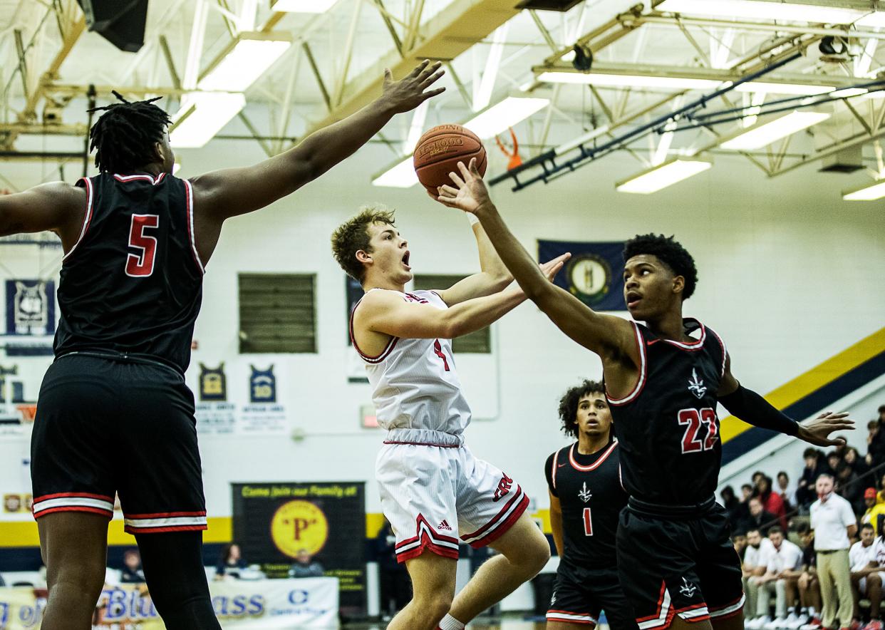 George Rogers Clark guard Aden Slone put up a floater in the lane against the Lake Highland defense during early action at the King of the Bluegrass basketball tournament at Fairdale High School. Dec. 18, 2021