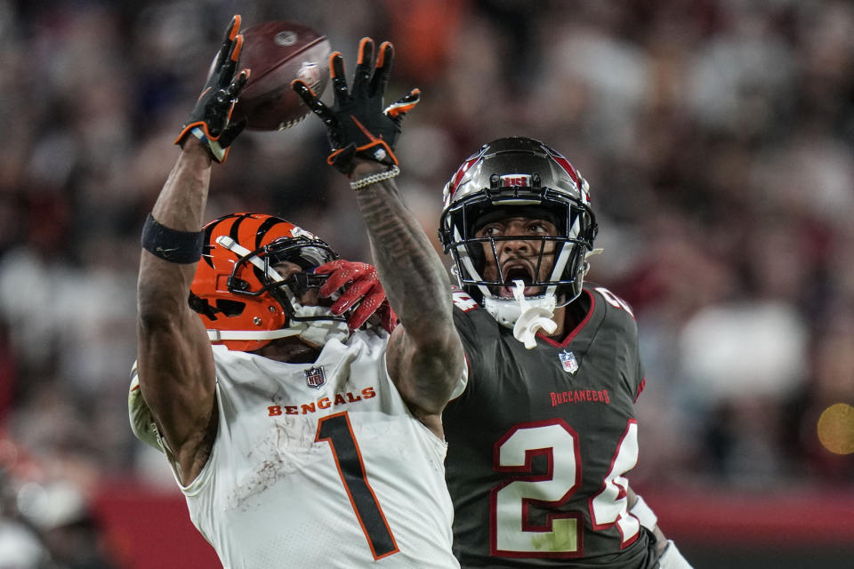 Cincinnati Bengals wide receiver Ja'Marr Chase (1) can't hang on to the pass as Tampa Bay Buccaneers cornerback Carlton Davis III (24) defends during the second half of an NFL football game, Sunday, Dec. 18, 2022, in Tampa, Fla. (AP Photo/Chris O'Meara)