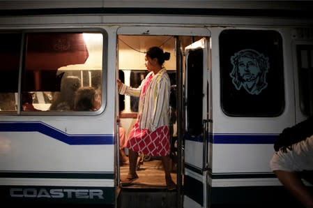 A girl stands in a bus before people were evacuated in San Lorenzo Community an area where wildfires have destroyed hectares of forest, near Robore