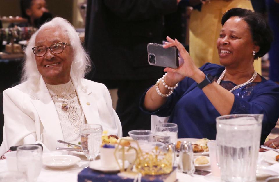 Velma Smoot, 97, smiles as her daughter Donna Smoot Walters takes a picture of their table mates at the mother-daughter luncheon Saturday.