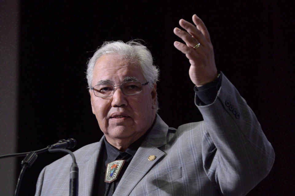 Commission chairman Justice Murray Sinclair raises his arm asking residential school survivors to stand at the Truth and Reconciliation Commission in Ottawa on June 2, 2015. (Photo by Adrian Wyld, The Canadian Press)