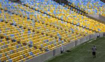 A worker carries a guardrail inside the Maracana stadium. Once the largest stadium in the world, holding about 200,000 people, it has downsized its capacity for the tournament to 74,698. (Sergio Moraes/Reuters)