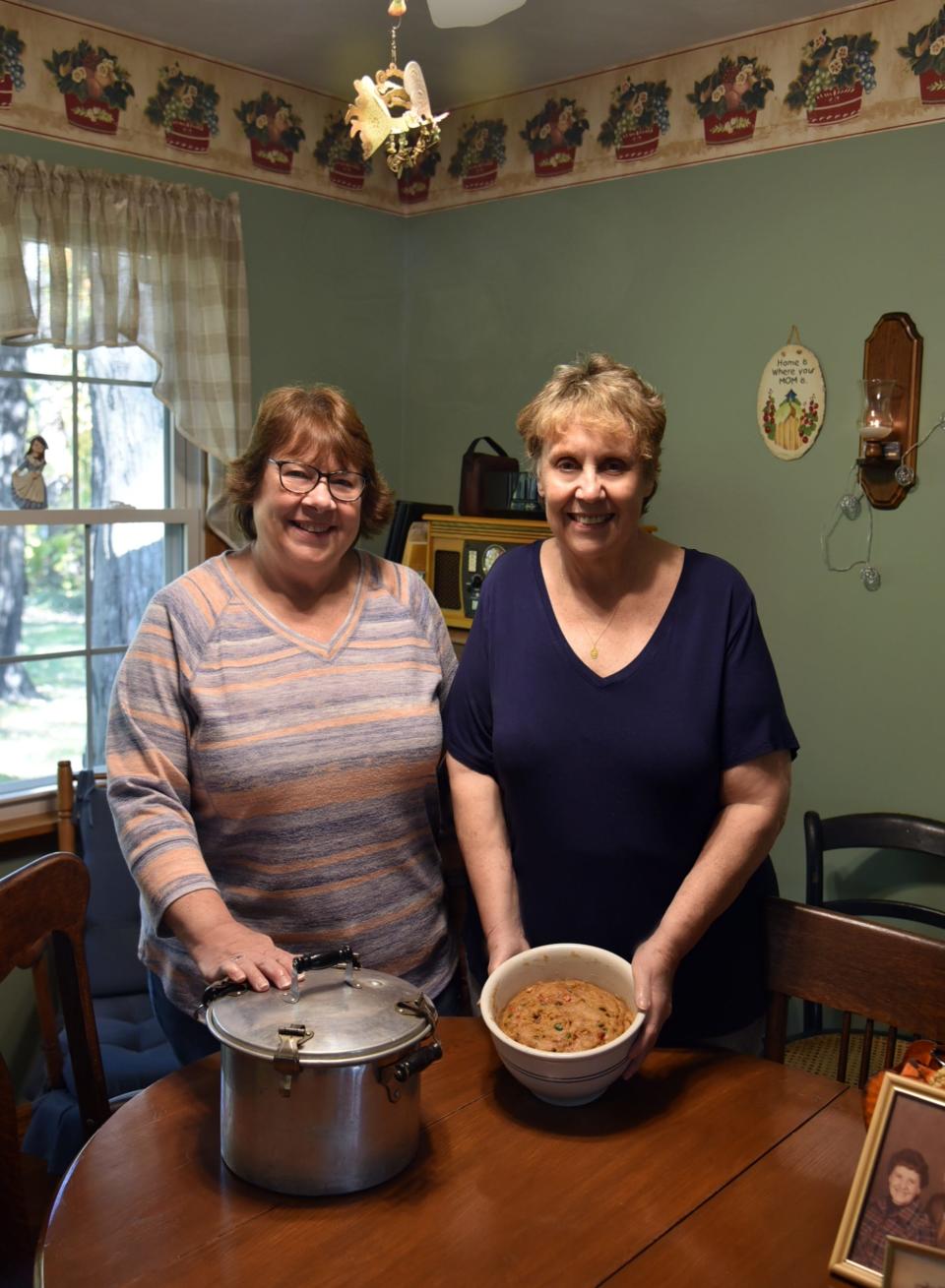 Maureen Yesh, gives sister Anne Osborn Good a helping hand making their family’s treasured ancestral English holiday treat.