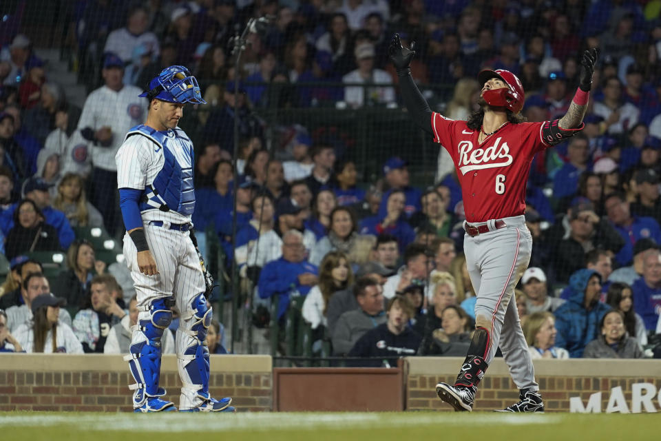 Cincinnati Reds' Jonathan India (6) throws up his hands as he walks by Chicago Cubs catcher Yan Gomes, left, to score his second two-run home run of a baseball game during the seventh inning, Saturday, May 27, 2023, in Chicago. (AP Photo/Erin Hooley)