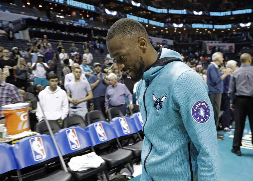 Charlotte Hornets' Kemba Walker eaves the court after the team's NBA basketball game against the Orlando Magic in Charlotte, N.C., Wednesday, April 10, 2019. (AP Photo/Chuck Burton)