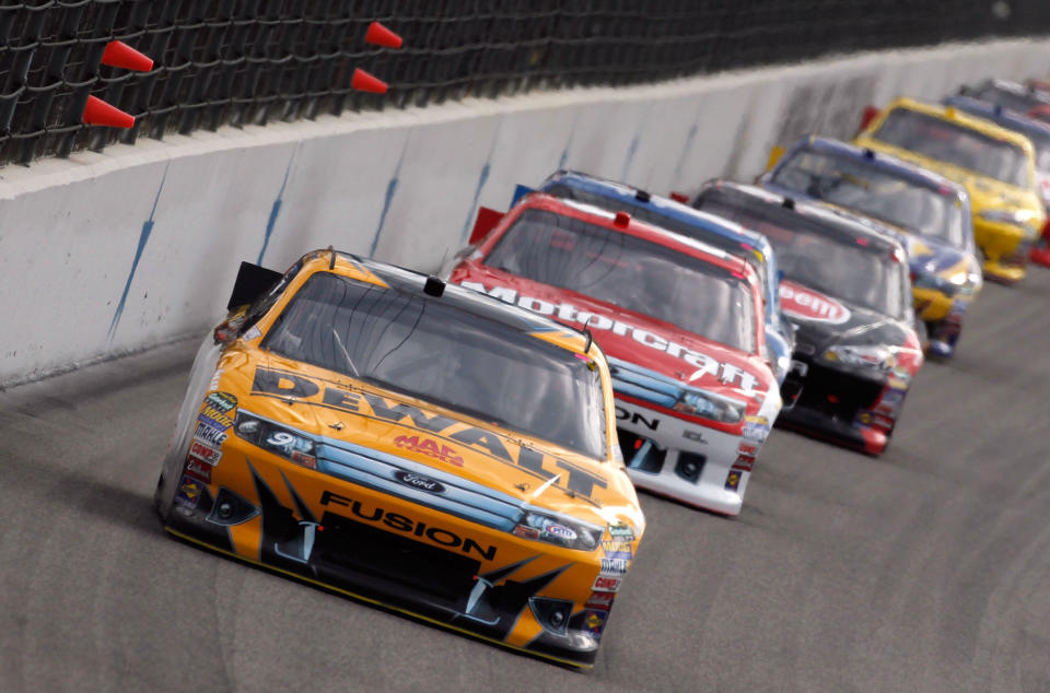 FORT WORTH, TX - NOVEMBER 06: Marcos Ambrose, driver of the #9 Dewalt Ford, leads a pack of cars during the NASCAR Sprint Cup Series AAA Texas 500 at Texas Motor Speedway on November 6, 2011 in Fort Worth, Texas. (Photo by Jonathan Ferrey/Getty Images)