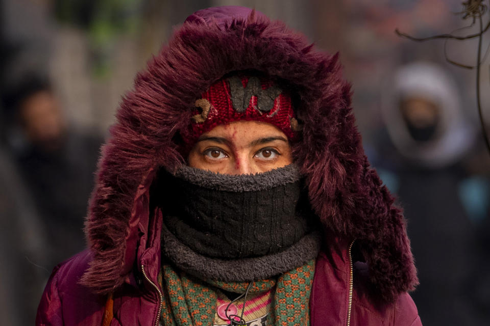 A Kashmiri woman walks with her face shielded from the cold on a cold morning in Srinagar, Indian controlled Kashmir, Wednesday, Jan. 3, 2024. (AP Photo/Dar Yasin)