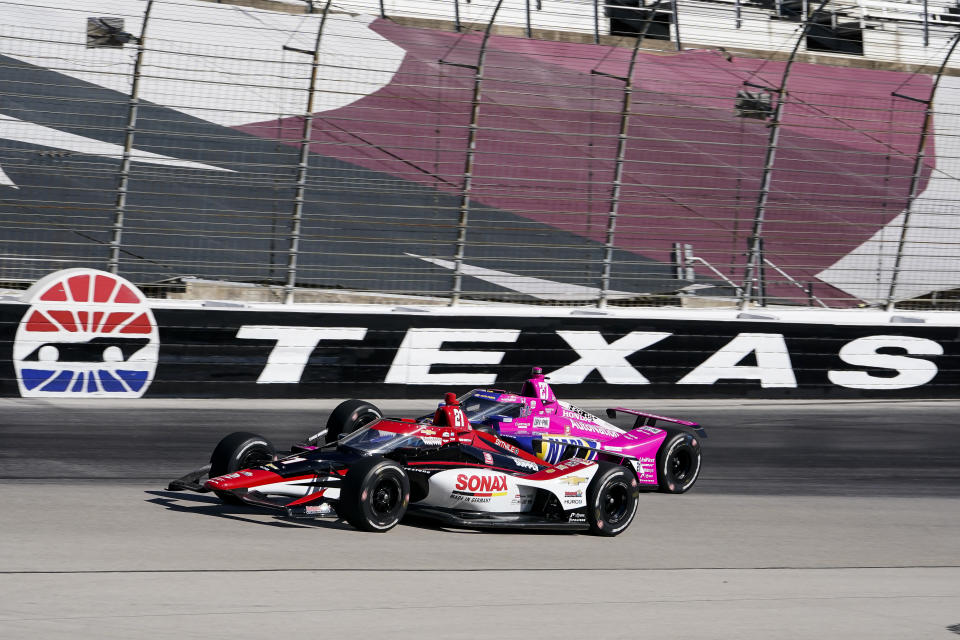 Rinus Veekay passes Alexander Rossi on the fourth turn during the first practice round of the IndyCar Series auto race at Texas Motor Speedway in Fort Worth, Texas on Saturday, March 19, 2022. (AP Photo/Larry Papke)