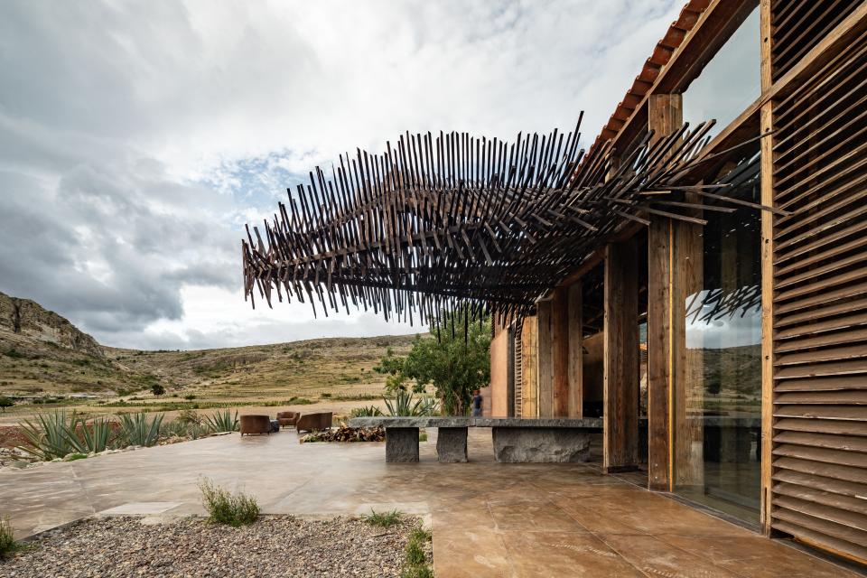 A communal table straddles the interior and exterior of Casa Silencio