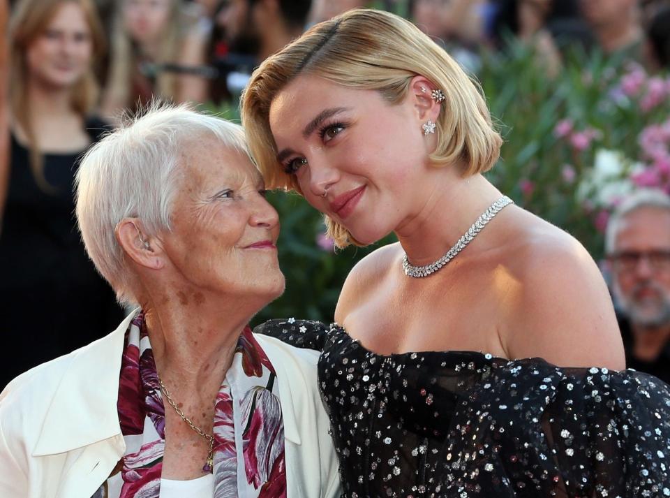 Florence leans her head on her grandma who is looking up at her and smiling